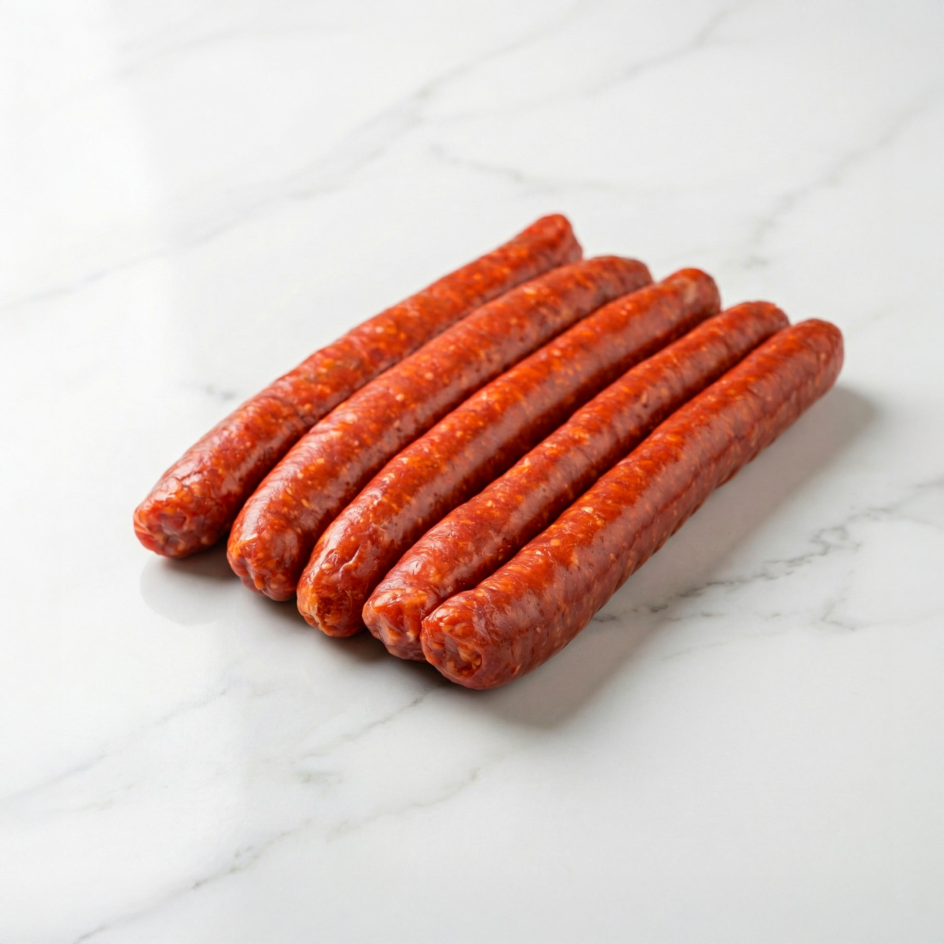 Merguez artisanales crues de bœuf et d'agneau préparées en atelier par La Boucherie s.a.