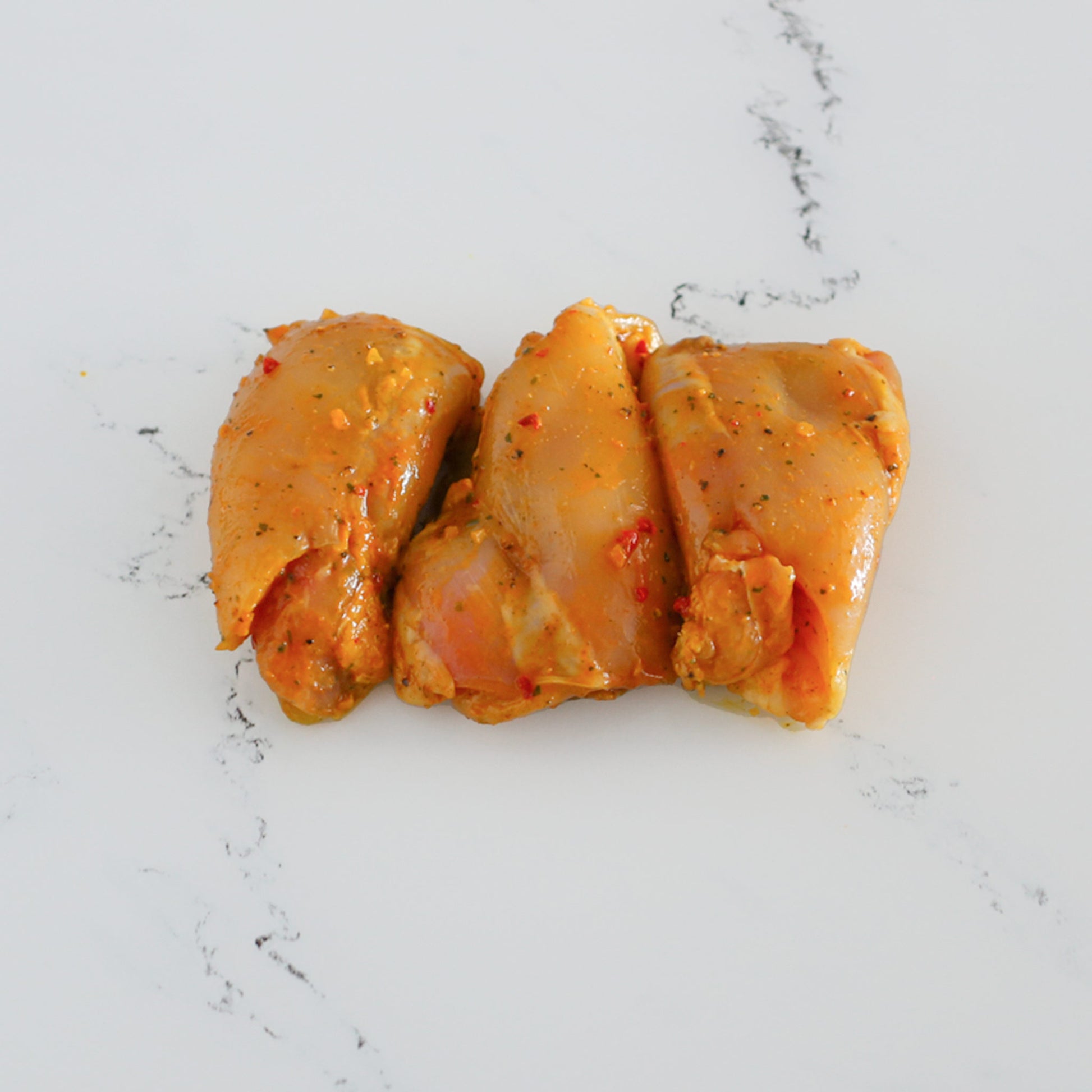 Hauts de cuisse de poulet marinés à l'Indienne | Votre boucherie en ligne | La Boucherie s.a.
